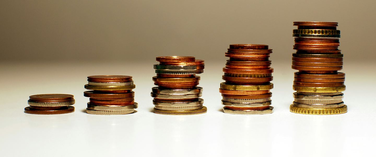 Five stacks of coins rising in height from left to right