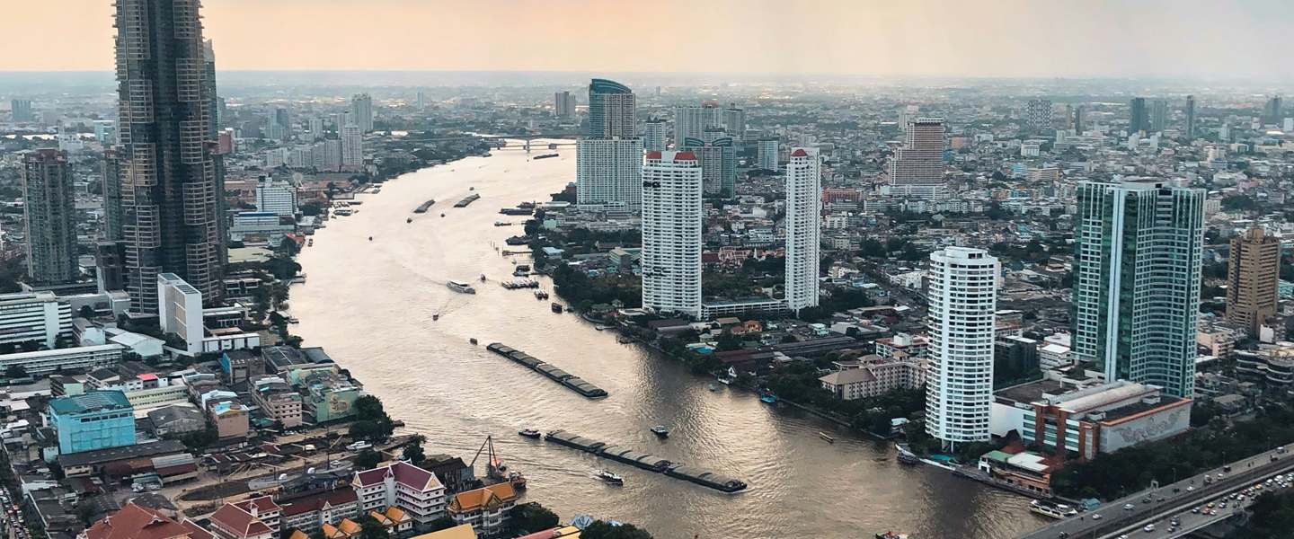 Bangkok from above: the Chao Phraya with barges, a road bridge and towers